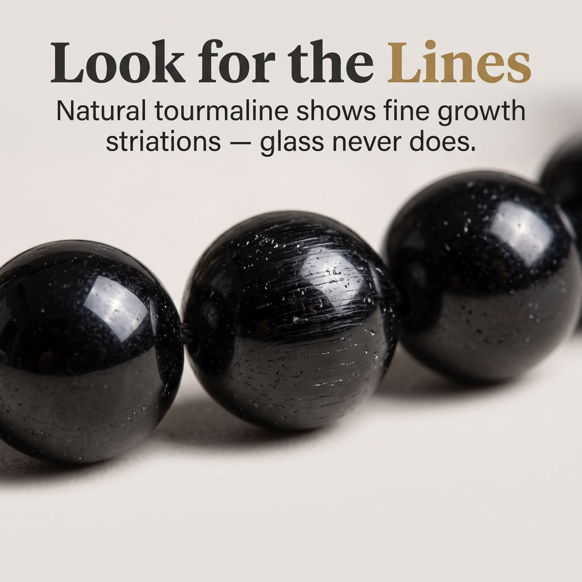 Natural black tourmaline bead close-up showing growth striations — how to spot real tourmaline, GemSense