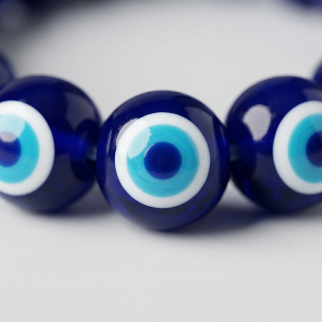 Evil eye nazar bead close-up — classic blue glass eye detail, GemSense bracelet